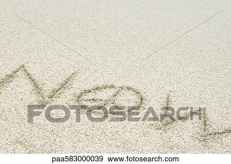 Stock Photo - The word "now" written with a peace sign in sand (peace now). Fotosearch