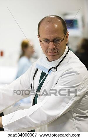 Stock Photo - Doctor busy at work. Fotosearch
