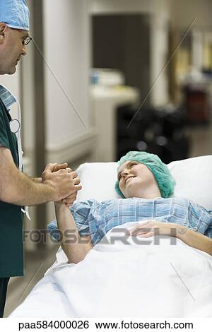 Doctor reassuring patient View Large Photo Image Stock Photograph - Doctor reassuring patient. Fotosearch