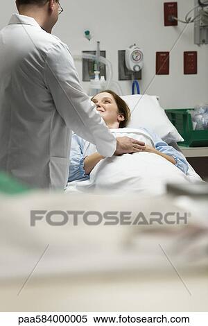 Doctor reassuring patient View Large Photo Image Stock Photography - Doctor reassuring patient. Fotosearch