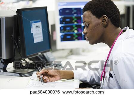 Doctor reviewing medical chart View Large Photo Image Stock Photograph - Doctor reviewing medical chart. Fotosearch