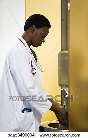 Stock Image - Doctor washing hands. Fotosearch