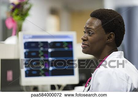 Healthcare worker at nurse's station View Large Photo Image Stock Image - Healthcare worker at nurse's station. Fotosearch