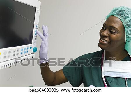 Healthcare worker changing settings on medical equipment monitor View Large Photo Image Stock Photography - Healthcare worker changing settings on medical equipment monitor. Fotosearch