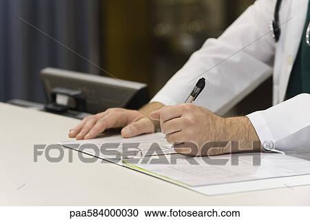 Healthcare worker completing document View Large Photo Image Stock Image - Healthcare worker completing document. Fotosearch