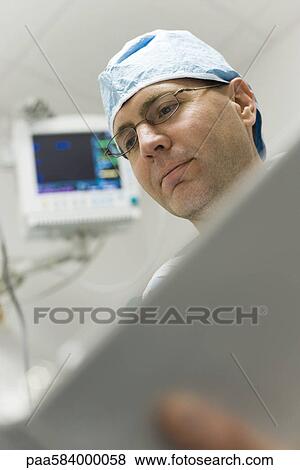 Healthcare worker focused on work View Large Photo Image Stock Photo - Healthcare worker focused on work. Fotosearch