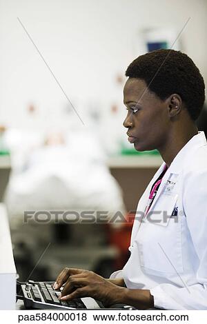 Healthcare worker using computer View Large Photo Image Stock Photo - Healthcare worker using computer. Fotosearch