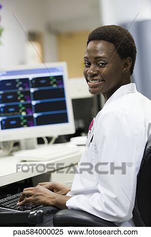 Healthcare worker using computer, portrait View Large Photo Image Stock Photography - Healthcare worker using computer, portrait. Fotosearch