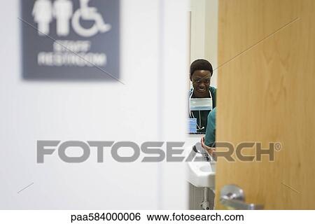 Healthcare worker washing hands in bathroom View Large Photo Image Stock Photograph - Healthcare worker washing hands in bathroom. Fotosearch