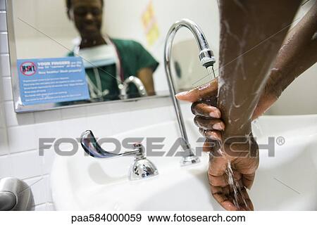 Healthcare worker washing hands View Large Photo Image Stock Photo - Healthcare worker washing hands. Fotosearch