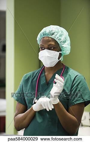 Nurse prepared to assist with medical procedure View Large Photo Image Stock Photo - Nurse prepared to assist with medical procedure. Fotosearch