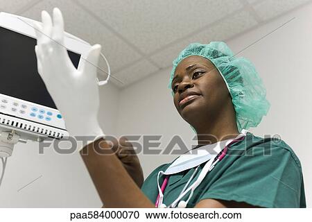 Nurse putting on latex gloves View Large Photo Image Stock Image - Nurse putting on latex gloves. Fotosearch