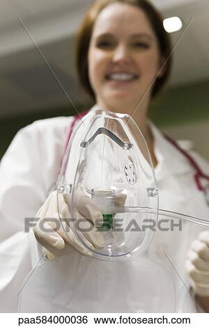 Nurse putting oxygen mask on patient, personal perspective View Large Photo Image Stock Photograph - Nurse putting oxygen mask on patient, personal perspective. Fotosearch