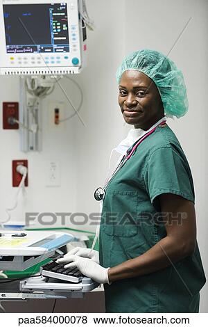 Nurse using computer in hospital room View Large Photo Image Stock Photo - Nurse using computer in hospital room. Fotosearch