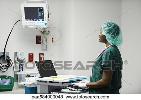Nurse using computerized medical equipment View Large Photo Image Stock Photo - Nurse using computerized medical equipment. Fotosearch