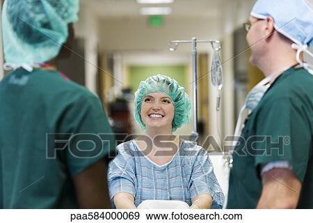 Stock Photo - Patient chatting with healthcare workers. Fotosearch