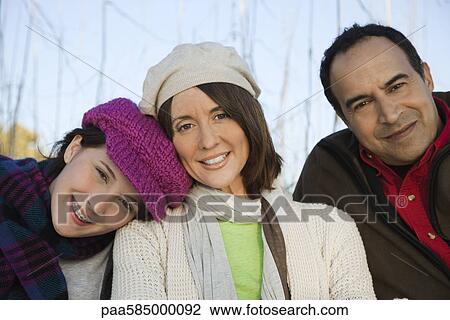 Stock Image - Family together outdoors, portrait. Fotosearch