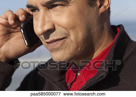 Stock Photo - Man using cell phone outdoors. Fotosearch
