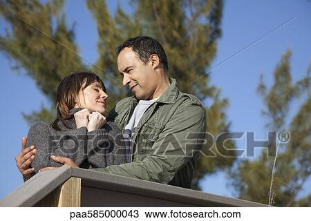 Mature couple embracing outdoors View Large Photo Image Stock Image - Mature couple embracing outdoors. Fotosearch