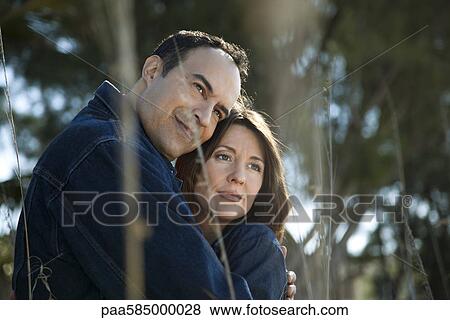 Mature couple embracing outdoors, portrait View Large Photo Image Stock Photo - Mature couple embracing outdoors, portrait. Fotosearch