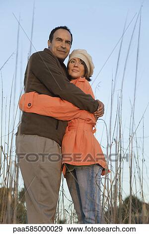 Mature couple embracing outdoors, portrait View Large Photo Image Stock Photo - Mature couple embracing outdoors, portrait. Fotosearch