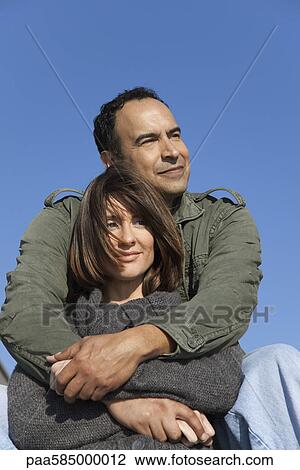 Mature couple relaxing together outdoors View Large Photo Image Stock Image - Mature couple relaxing together outdoors. Fotosearch