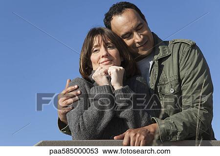 Mature couple relaxing together outdoors View Large Photo Image Stock Image - Mature couple relaxing together outdoors. Fotosearch
