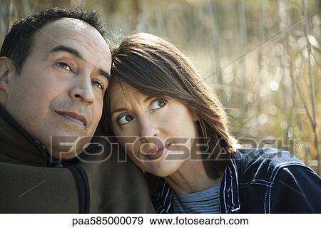 Mature couple relaxing together outdoors View Large Photo Image Stock Photo - Mature couple relaxing together outdoors. Fotosearch