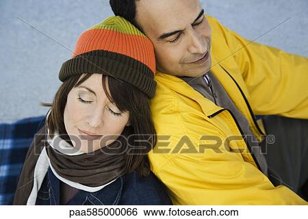 Stock Photograph - Mature couple relaxing together outdoors. Fotosearch