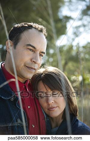 Mature couple relaxing together outdoors, portrait View Large Photo Image Stock Photo - Mature couple relaxing together outdoors, portrait. Fotosearch