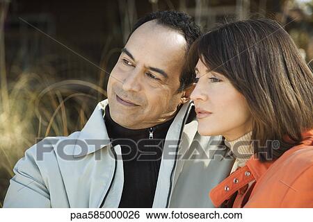 Stock Photograph - Mature couple relaxing together outdoors, portrait. Fotosearch