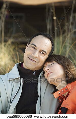 Mature couple relaxing together outdoors, portrait View Large Photo Image Stock Photograph - Mature couple relaxing together outdoors, portrait. Fotosearch