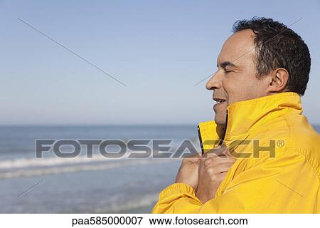 Mature man at the beach on a chilly day, eyes closed, portrait View Large Photo Image Stock Photo - Mature man at the beach on a chilly day, eyes closed, portrait. Fotosearch