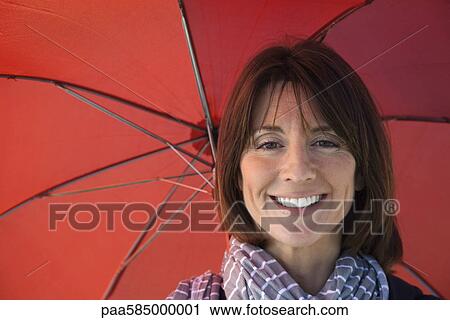 Mature woman under umbrella, portrait View Large Photo Image Stock Image - Mature woman under umbrella, portrait. Fotosearch