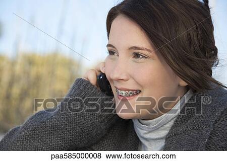Stock Photo - Teen girl talking on cell phone. Fotosearch