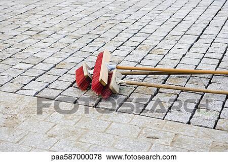 Brooms on cobblestone street View Large Photo Image Stock Photo - Brooms on cobblestone street. Fotosearch