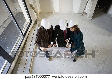 Building contractor and business people discussing blueprint View Large Photo Image Stock Photo - Building contractor and business people discussing blueprint. Fotosearch