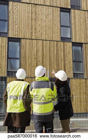 Stock Photograph - Building contractor and business people in discussion. Fotosearch