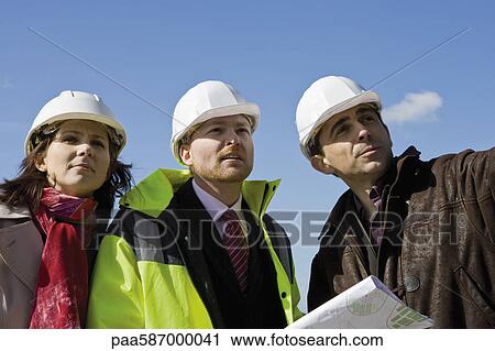 Building contractor and business associates discussing project View Large Photo Image Stock Image - Building contractor and business associates discussing project. Fotosearch
