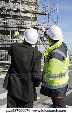 Building contractor and businessman at construction site View Large Photo Image Stock Photograph - Building contractor and businessman at construction site. Fotosearch