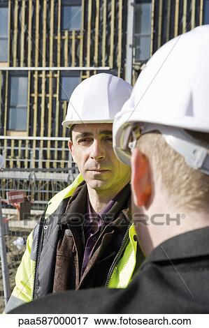 Stock Photo - Building contractor having conversation with site foreman. Fotosearch