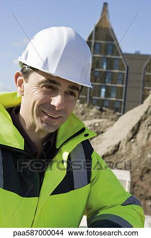 Building contractor in hard hat and reflective clothing, portrait View Large Photo Image Picture - Building contractor in hard hat and reflective clothing, portrait. Fotosearch