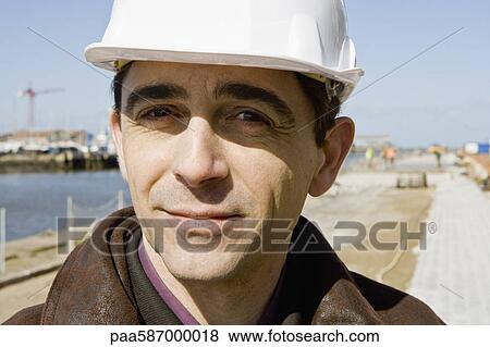 Stock Photo - Building contractor in hard hat, portrait. Fotosearch