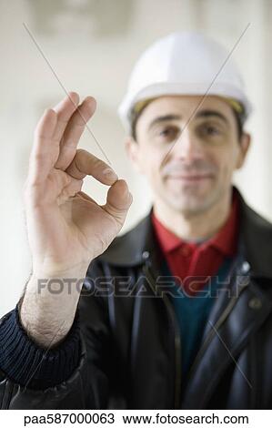 Building contractor making OK sign View Large Photo Image Stock Image - Building contractor making OK sign. Fotosearch