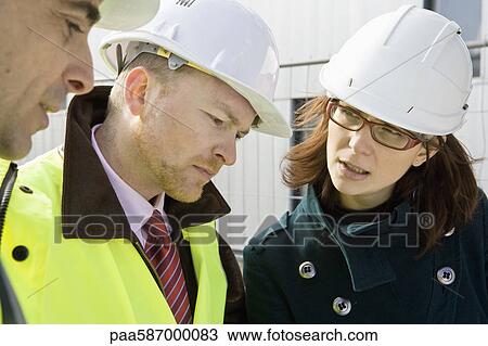 Business people in discussion at construction site View Large Photo Image Stock Image - Business people in discussion at construction site. Fotosearch