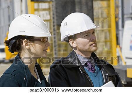 Stock Photography - Business people in hard hats. Fotosearch