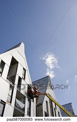 Cherry picker and incomplete building exterior View Large Photo Image Stock Image - Cherry picker and incomplete building exterior. Fotosearch