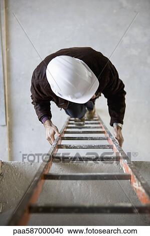 Construction worker climbing ladder View Large Photo Image Stock Image - Construction worker climbing ladder. Fotosearch