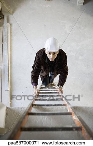 Construction worker climbing ladder View Large Photo Image Stock Image - Construction worker climbing ladder. Fotosearch