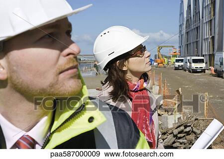 Stock Photo - Contractors at construction site. Fotosearch